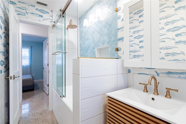 bathroom with speckled floor, vanity, and visible vents