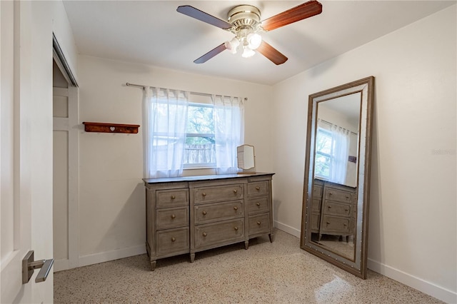 bedroom featuring light speckled floor, a ceiling fan, and baseboards
