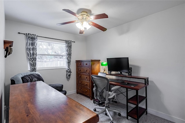 home office with light speckled floor, a ceiling fan, and baseboards