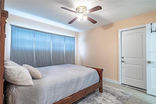 bedroom featuring ceiling fan and baseboards