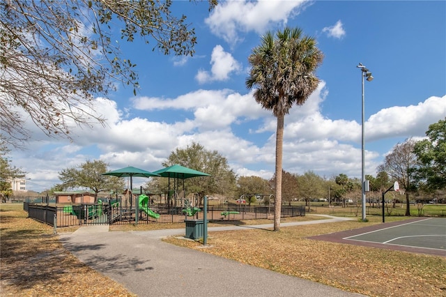 surrounding community featuring community basketball court, fence, and playground community