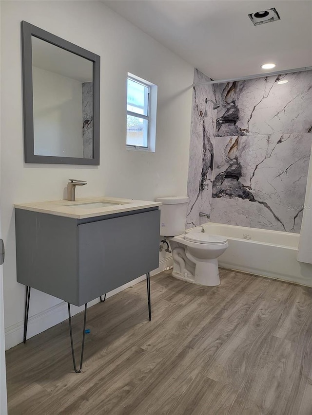 full bathroom featuring shower / bathing tub combination, vanity, toilet, and wood finished floors