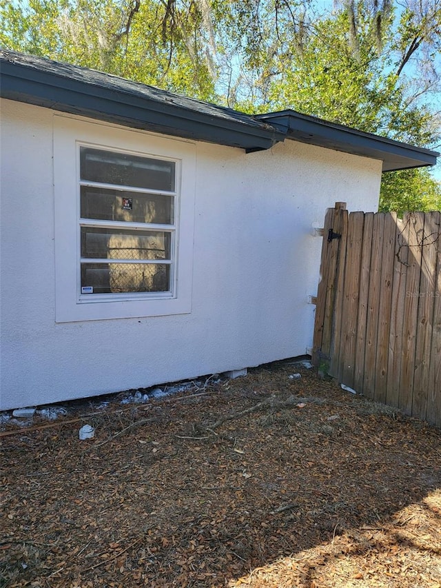 view of home's exterior featuring fence and stucco siding