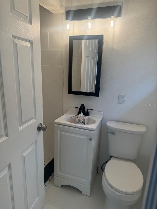 half bathroom with toilet and vanity