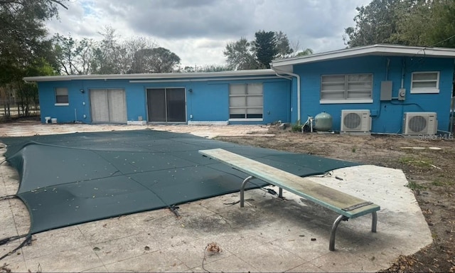 exterior space with ac unit and a covered pool