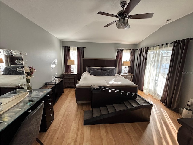 bedroom with lofted ceiling, light wood-type flooring, and ceiling fan