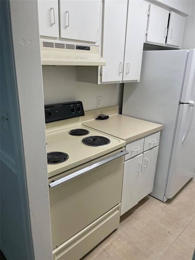 kitchen featuring light countertops, white appliances, white cabinetry, and under cabinet range hood