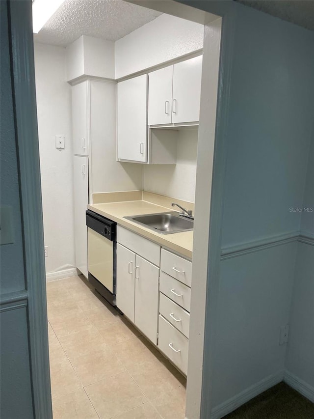 kitchen with a textured ceiling, a sink, white cabinets, light countertops, and dishwasher