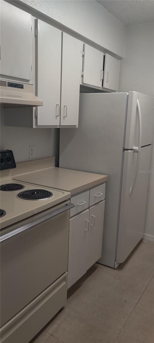 kitchen with white electric range oven, light countertops, white cabinetry, a textured ceiling, and under cabinet range hood