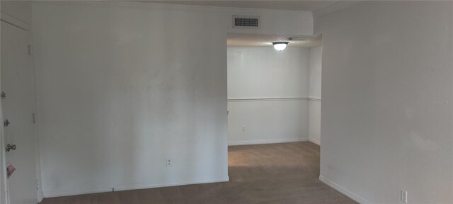 unfurnished room with visible vents and baseboards