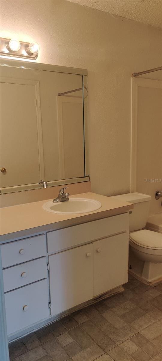 full bath with toilet and vanity