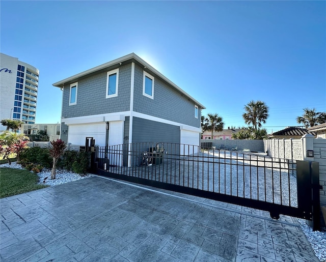 exterior space with fence and concrete driveway