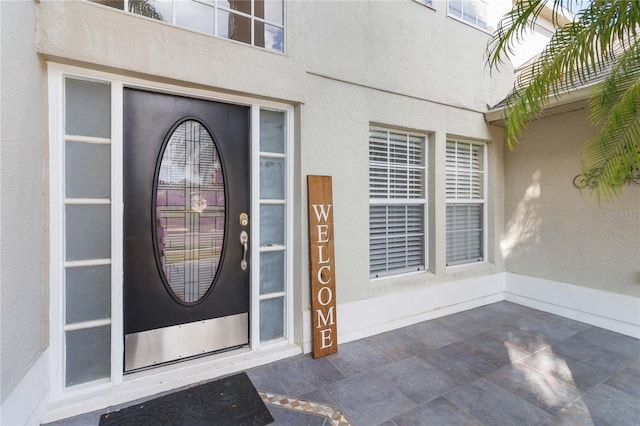 doorway to property with stucco siding