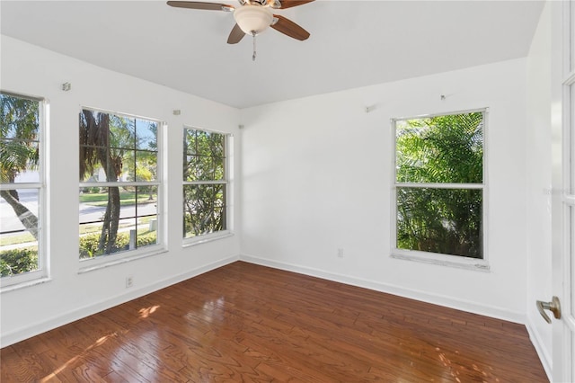 spare room featuring ceiling fan, hardwood / wood-style floors, and baseboards