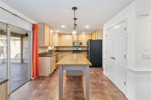 kitchen with decorative light fixtures, decorative backsplash, appliances with stainless steel finishes, light tile patterned flooring, and wood counters