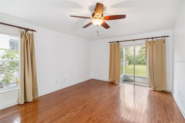 spare room featuring ceiling fan, baseboards, and hardwood / wood-style flooring