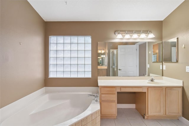 bathroom featuring a stall shower, vanity, a bath, and tile patterned floors