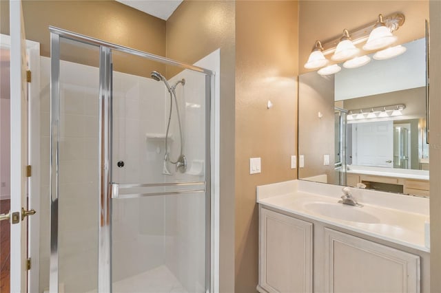 bathroom featuring a shower stall and vanity