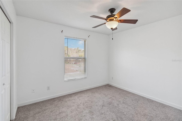 unfurnished bedroom featuring carpet floors, a ceiling fan, baseboards, and a closet