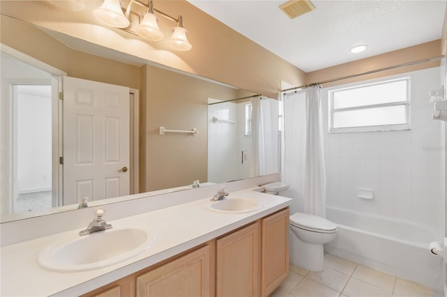 full bath with shower / bath combo, visible vents, a sink, and tile patterned floors