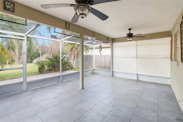 unfurnished sunroom with a ceiling fan