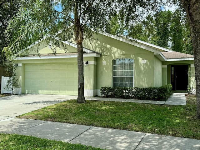 ranch-style home with an attached garage, driveway, a front lawn, and stucco siding