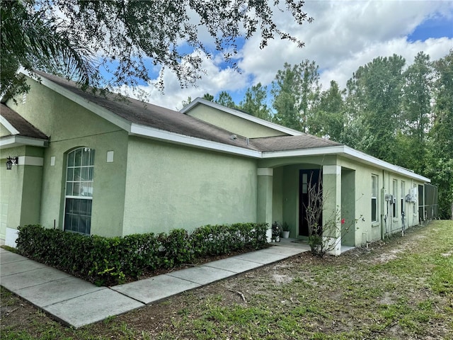 view of property exterior with a garage and stucco siding