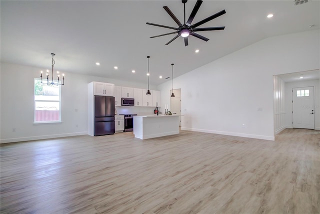 unfurnished living room featuring recessed lighting, visible vents, light wood-style floors, baseboards, and ceiling fan with notable chandelier