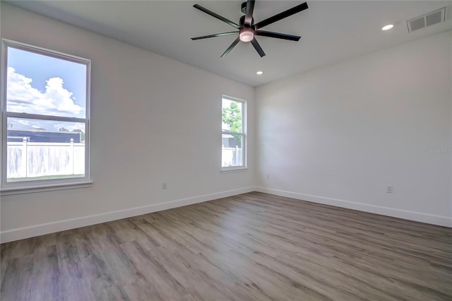 unfurnished room featuring baseboards, visible vents, a ceiling fan, wood finished floors, and recessed lighting