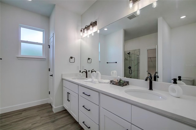 full bath with baseboards, a sink, visible vents, and a shower stall