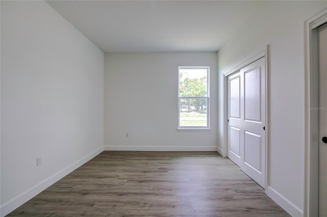 empty room featuring baseboards and wood finished floors