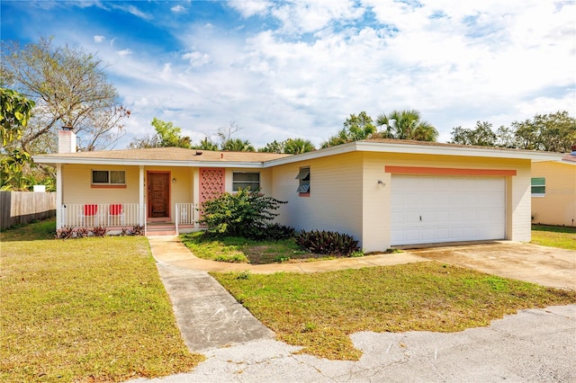 ranch-style home with concrete driveway, a front lawn, a chimney, and an attached garage