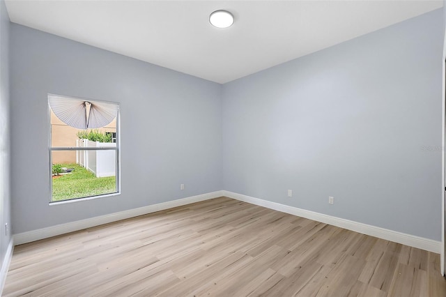 empty room featuring light wood-style flooring and baseboards