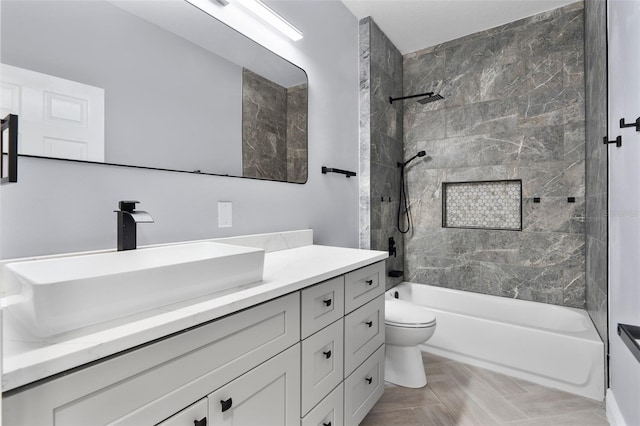 bathroom featuring vanity, toilet, and shower / bathtub combination