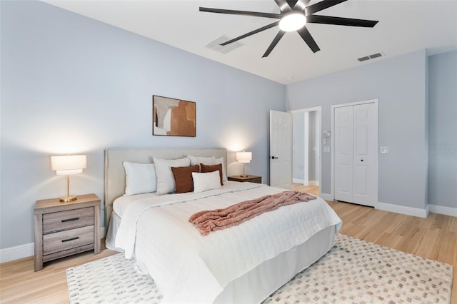 bedroom with light wood-type flooring, baseboards, and visible vents