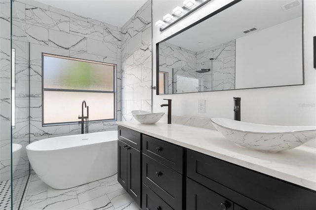 bathroom with a soaking tub, a sink, marble finish floor, and a marble finish shower