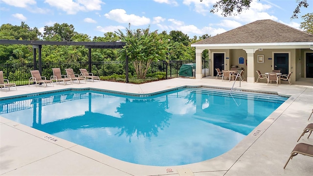 community pool with fence and a patio