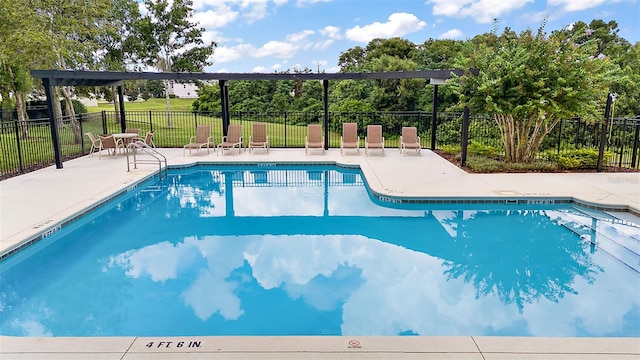 pool with a patio area, fence, and a lawn