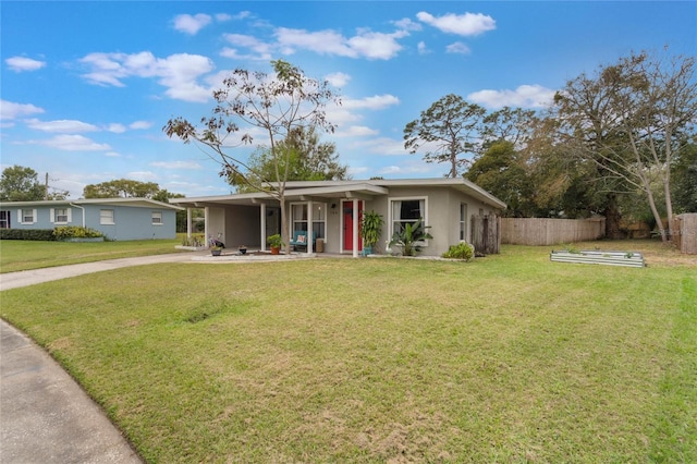 ranch-style home featuring a carport, concrete driveway, fence, and a front lawn