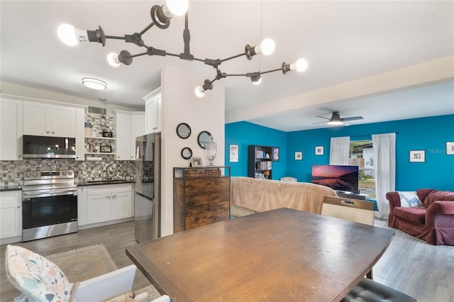 dining area featuring a ceiling fan and dark wood-style flooring