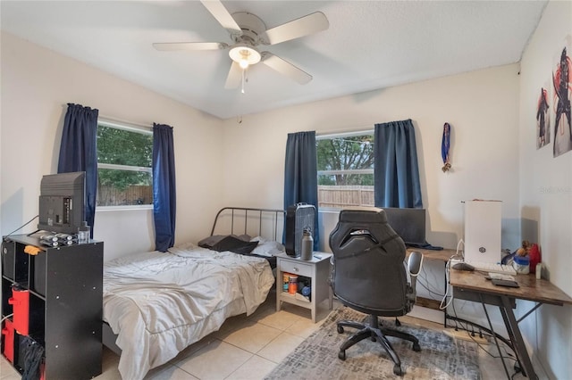 bedroom with a ceiling fan and light tile patterned flooring