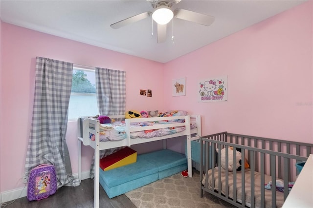 bedroom with wood finished floors, a ceiling fan, and baseboards