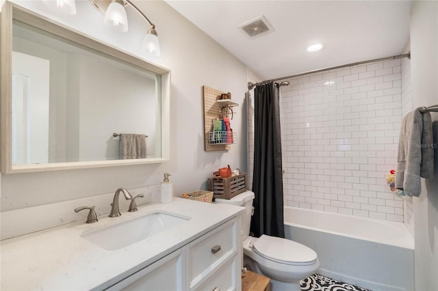 full bathroom featuring toilet, vanity, shower / bath combo with shower curtain, and visible vents