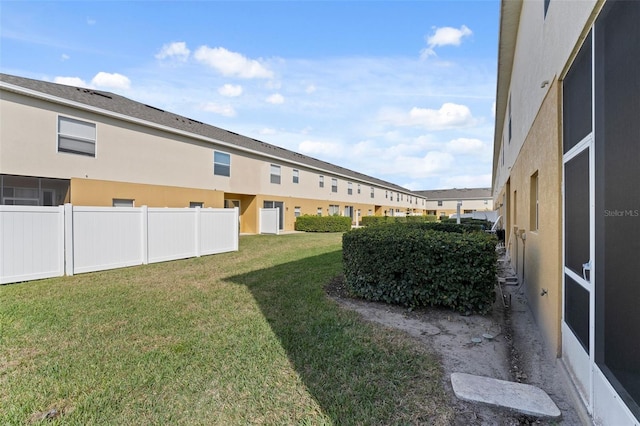 view of yard with fence and a residential view