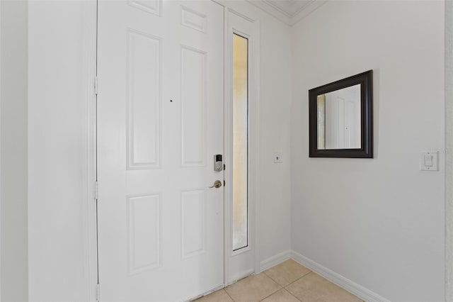 doorway featuring crown molding, baseboards, and light tile patterned floors