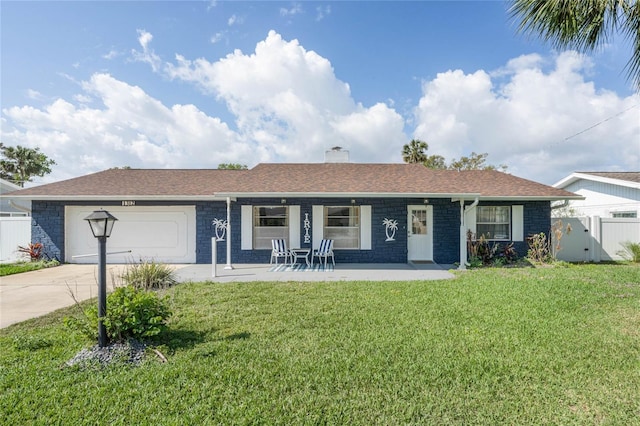 ranch-style home featuring a garage, driveway, a chimney, and a front yard