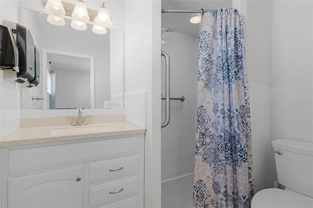 bathroom featuring tile walls, vanity, toilet, and a shower with curtain