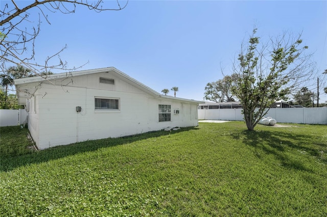 back of house featuring a yard and fence