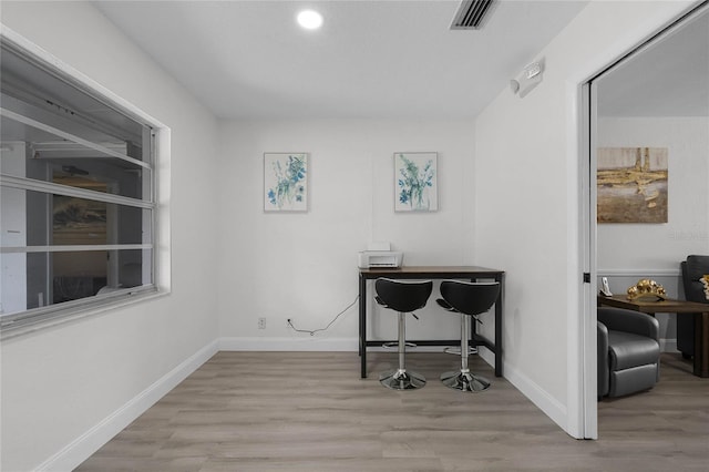 home office featuring light wood-style floors, baseboards, and visible vents