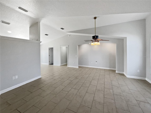 unfurnished room with lofted ceiling, ceiling fan, and visible vents